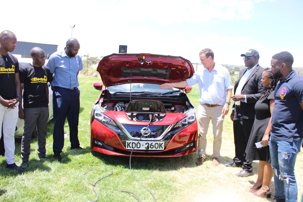 Tom Morton (centre) an electric car owner shows the Nissan leaf EV to attendants during the Electric Vehicle Expo in Buffalo Mall, Naivasha on 14/4/22. From Right: Iyadi O Iyadi Director EVCHAJA, Bertha Mvati Managing Director of VAELL Leasing, Jared Oundo the Executive Director Jubilant Stewards of Africa. From far left: Bramwel Randiga and Dennis Owuoche of VAELL Leasing and John Roman of African EV. Image: Jared Rasugu